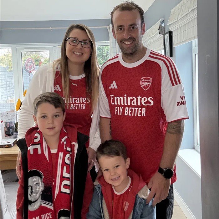 Elle and her family in their Arsenal shirts at home